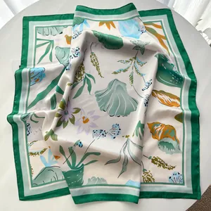 Detail of silk square scarf featuring tropical leaves, flowers and sea shell prints