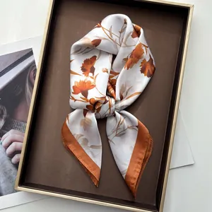 Elegant silk-like square scarf featuring carnation floral patterns on cream fabric