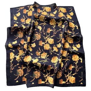Elegant carnation floral print silk scarf with yellow and orange blossoms on dark base