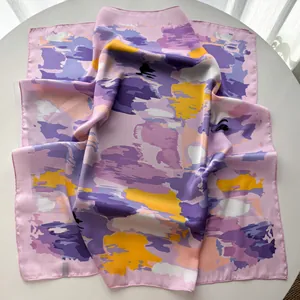 Detailed macro view of French style striped floral silk scarf with smooth satin texture
