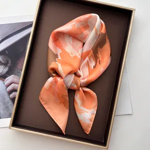 Detailed view of striped floral silk square scarf in a premium brown gift box
