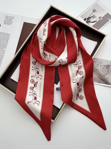 Close-up of red satin scarf with vintage horse carriage print in a gift box packaging