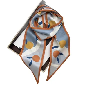 Elegant fruit print satin silk scarf in light blue and orange on a stylish gift box