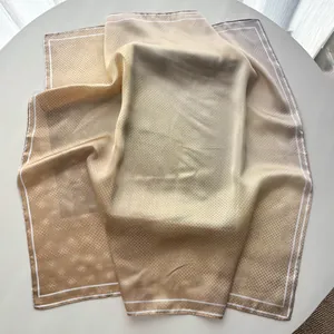 Detail of classic polka dot scarf showing beige gradient texture and soft silk-like fabric
