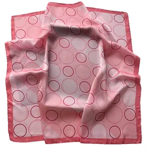 Pink silk square scarf featuring modern geometric circle prints and high-quality finish