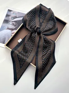 Detail of premium satin silk scarf featuring elegant horse shoe print and smooth texture