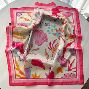 Detail view of floral shell print silk scarf showing soft fabric texture and glossy finish