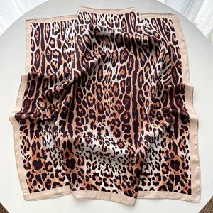 Detailed view of leopard print satin square scarf showing soft texture and silk sheen