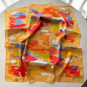 Macro view of luxurious yellow square silk scarf with multi-color abstract art splash pattern