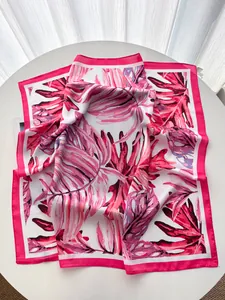 Detailed view of monstera palm leaf print on luxury satin silk square scarf shawl