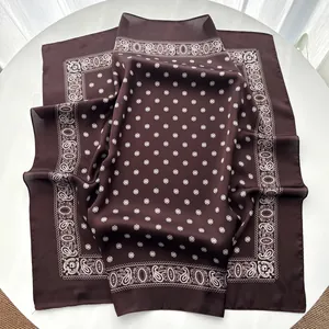 Detail view of smooth silk-like dark brown square scarf with white paisley patterns