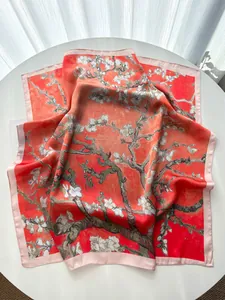 Detailed macro shot of coral orange silk scarf featuring Van Gogh almond blossom print