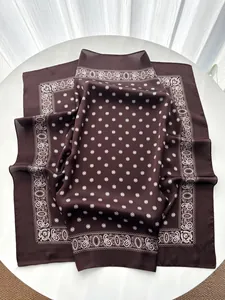 Detail of soft silk-like fabric with paisley borders and geometric star patterns