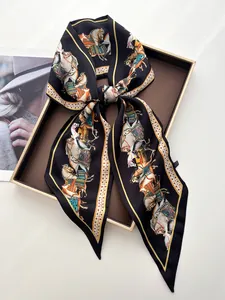 Detail of elegant black silk satin scarf with equestrian horse print tied in a bow