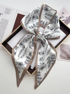 Macro detail of silk-like twilly scarf with floral prints and contrast border