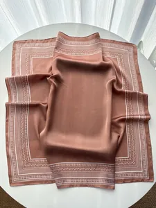 Detail of silk-like paisley square scarf with vintage print and elegant satin texture