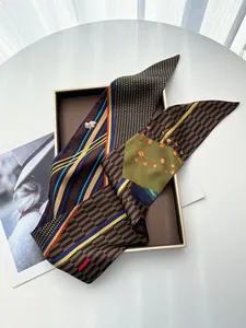 Detailed close-up of multi-color striped satin scarf draped over a classic gift box
