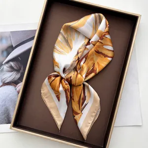 Elegant silk scarf with yellow plant print inside a premium gift box set