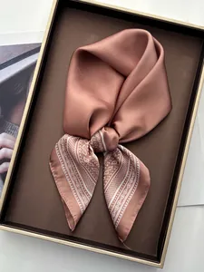 Detail of silk-like satin square scarf with paisley print in a premium gift box