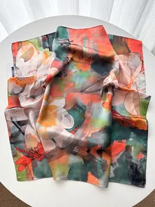 Artistic detail of silk scarf featuring floral lotus and red dragonfly ink painting