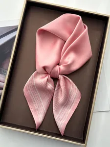 Detailed view of pink paisley satin scarf texture with elegant white silk patterns