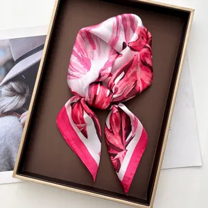 Lustrous silk-feel scarf with pink tropical monstera leaf print in a premium gift box