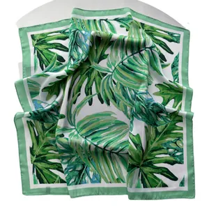 Tropical monstera leaf print silk scarf with green border for elegant spring styling