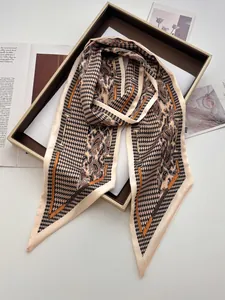 Detail of silk satin twilly scarf with houndstooth and paisley prints in a gift box