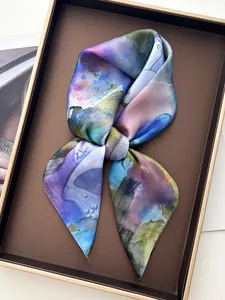 Detail of silk scarf with multi-color artistic ink pattern in a premium gift box