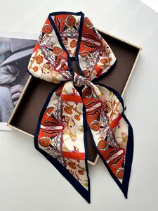 Detail of equestrian silk scarf tied in bow featuring horse motifs and orange border