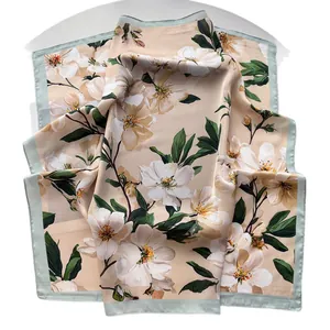 Elegant peach blossom printed silk scarf in beige with floral patterns and green borders