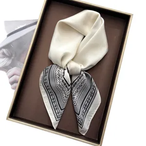 Elegant paisley print silk square scarf neatly displayed in a premium gift box