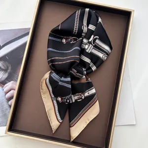 Detailed view of silk square scarf featuring vintage golden chain and belt print patterns