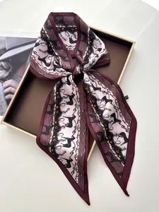 Macro shot of horse and chain print satin silk scarf in a vintage gift box