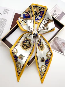 Elegant crown print twilly silk scarf folded as a bow in a luxury gift box packaging