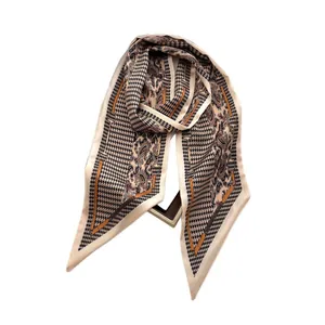 Houndstooth and paisley print satin scarf with equestrian motif on a display frame