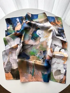 Detailed view of lightweight silk square scarf with floral prints and dragonfly patterns