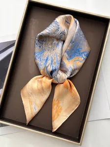 Detailed view of silk square scarf with abstract oil painting print in a gift box