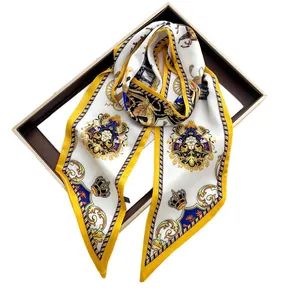 Elegant white and yellow silk scarf with crown and carriage print on a gift box