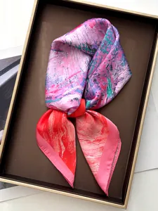 Detail shot of silk-feel scarf with abstract oil painting print in a display tray