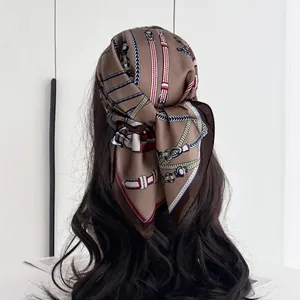 Detailed view of a vintage chain print silk scarf styled as a fashion headband