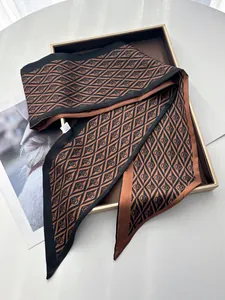 Detailed view of luxury silk twilly scarf with diamond pattern on elegant gift box