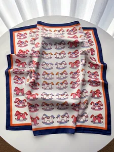 Close-up of silk-like scarf with playful rocking horse print and colorful border
