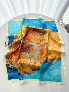 Detailed close-up of Van Gogh sunflower print silk scarf on white table with soft light
