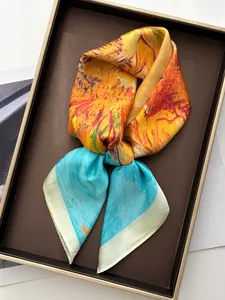 Artistic oil painting silk scarf with hand-rolled edges on a metallic display tray