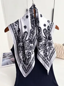 Detail of silk-like square scarf with vintage black paisley print on white fabric