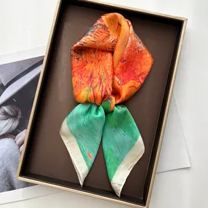Detail of silk scarf with impressionist oil painting print in orange and green