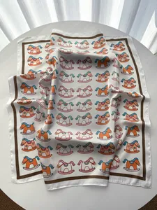 Macro detail of high-quality silk scarf with playful rocking horse print and soft texture