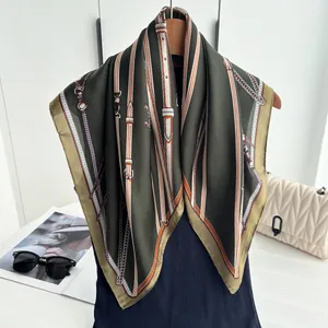 Detail of silk-like olive green scarf with horse harness pattern and chain print details