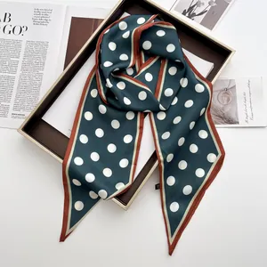 Polka dot silk scarf in dark green silk satin displayed in a decorative box